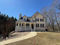 Charming two-story home with a welcoming front porch and well-manicured lawn at 274 Sleepy Hollow Rd, Powder Springs, GA 30127