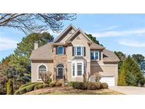 Stunning stucco home featuring a stone facade, manicured landscaping, and a welcoming front entrance at 3640 Ridgeway Ter, Suwanee, GA 30024