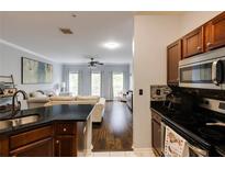 Open concept living space featuring a modern kitchen, hardwood floors, and abundant natural light at 5641 Roswell Rd # 307, Sandy Springs, GA 30342