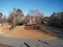 Traditional brick home with an attached garage and circular driveway on a landscaped lot at 5700 Thrasher Ln, Conyers, GA 30094
