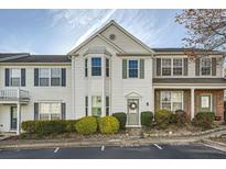 Traditional-style townhouse featuring white siding, bay window, and a charming front entrance at 2015 Kilmington Sq, Alpharetta, GA 30009