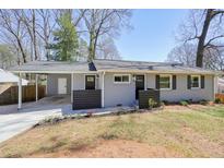 Charming single-story home with gray brick, black shutters, and a cozy front porch at 4985 Crowe Se Dr, Smyrna, GA 30082