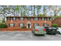 Attractive two-story brick apartment building with manicured landscaping, plenty of parking, and black window shutters at 3665 Chestnut Dr # A2, Atlanta, GA 30340