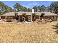 Charming single-story brick home with a well-maintained front yard and mature landscaping at 105 Creekwood Ln, Fayetteville, GA 30214