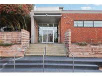 Building entrance featuring brick facade, glass doors and stairwell, located at 195 Arizona Avenue at 195 Arizona Ne Ave # 131, Atlanta, GA 30307