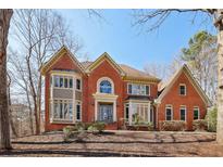 Beautiful brick home with detailed trim, large windows, and manicured landscaping on a sunny day at 2975 Coles Way, Atlanta, GA 30350