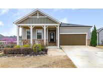 Charming single Gathering home with 1-car garage and manicured front yard at 525 Appalachian Pl, Canton, GA 30114