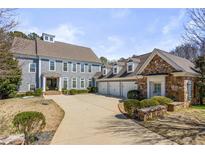 Beautiful two-story home featuring a stone and siding exterior, a spacious driveway and three-car garage at 3185 Casteel Ne Rd, Marietta, GA 30062