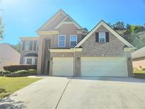 Charming two-story home featuring a two-car garage and manicured landscaping at 1172 Preserve Park Dr, Loganville, GA 30052