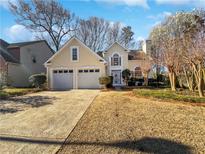 Charming two-story home with a two-car garage and well-maintained landscaping in a suburban neighborhood at 781 Soaring Dr, Marietta, GA 30062