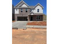 New two-story home features a brick facade, attached garage and a concrete driveway at 1104 Georgian Point Dr, Lawrenceville, GA 30045