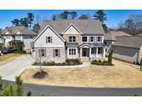 Charming two-story home with brick and stone accents, complemented by a well-manicured lawn at 1775 Rockwater Rd, Marietta, GA 30066
