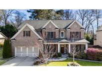 Beautiful two-story brick home with a meticulously maintained front yard and a three-car garage at 1106 Garner Creek Dr, Lilburn, GA 30047
