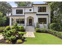 Charming two-story brick home with manicured lawn and inviting front entrance at 159 E Wesley Ne Rd, Atlanta, GA 30305