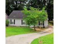 Charming single-story home featuring a well-manicured lawn and a long driveway, great for curb appeal at 9161 Fairway Ct, Riverdale, GA 30274