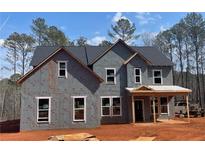 New home under construction featuring a classic two-story design and large windows for ample natural light at 3292 Mill Forest Sw Dr, Conyers, GA 30094