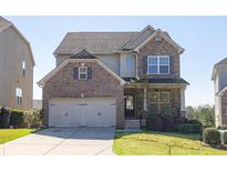 Charming two-story home with a brick and stone facade and a well-manicured front lawn at 5888 Cobblestone Creek Cir, Mableton, GA 30126
