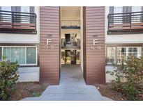 Condo exterior with well-kept grounds, wood accents, and stairs to multiple floors at 1445 Monroe Ne Dr # 14F, Atlanta, GA 30324