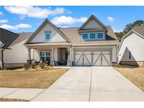 Charming, Craftsman-style home with a well-manicured lawn, covered porch and two car garage in a desirable neighborhood at 2638 Songbird Ln, Grayson, GA 30017