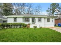 Charming brick home boasts a well-manicured lawn and neat landscaping at 733 Pegg Sw Rd, Atlanta, GA 30315