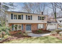 Charming two-story home featuring brick and siding with blue shutters and a manicured front yard at 2242 Greencrest Ne Dr, Atlanta, GA 30345