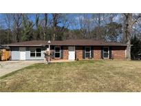 Charming single-story home featuring a brick facade and well-maintained front yard, perfect for suburban living at 781 E Glochester Pl, Norcross, GA 30071