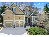 Inviting two-story home with a well-manicured lawn, a two car garage, and stone and siding accents at 1463 Bailey Farm Sw Dr, Marietta, GA 30064