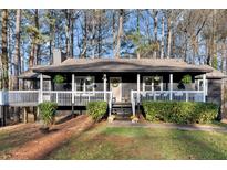 Charming home featuring a cozy front porch, well-maintained landscaping, and inviting curb appeal at 3171 Jessica Dr, Douglasville, GA 30135