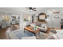 Open-concept living room features a ceiling fan and a comfortable seating arrangement at 3171 Jessica Dr, Douglasville, GA 30135