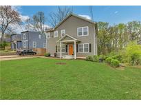 Charming two-story home with well-manicured lawn and welcoming orange front door at 1944 Lakewood Se Ter, Atlanta, GA 30315