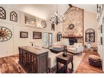Cozy living room with stone fireplace, hardwood floors, and abundant natural light at 1438 Janmar Rd, Snellville, GA 30078