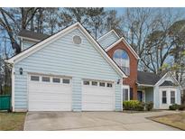 Charming home featuring a two-car garage, light blue siding, and brick accents at 2770 Da Vinci Cres, Decatur, GA 30034