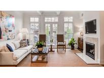 Bright living room features a fireplace, large windows, and comfortable seating at 45 Honour Nw Ave, Atlanta, GA 30305