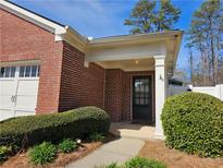 Charming brick home featuring a covered front door and manicured landscaping at 4071 Cottage Oaks Dr # 3, Acworth, GA 30101