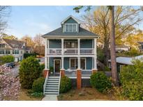 Charming two-story home with a double front porch, a yard, and beautiful landscaping at 243 Sterling St, Decatur, GA 30030