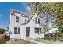 Charming white brick two-story home with landscaped front yard and black framed windows at 3395 Lee St, East Point, GA 30344