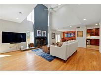 Bright living room featuring a vaulted ceiling, fireplace, and hardwood floors at 1325 S Ponce De Leon Ne Ave, Atlanta, GA 30306