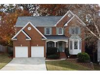 Charming two-story brick home with a well-manicured front yard and a two-car garage at 912 Tanners Point Dr, Lawrenceville, GA 30044