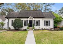 Charming home with a well-manicured lawn, walkway, and neatly trimmed bushes in front at 5 Arc Ne Way, Atlanta, GA 30305