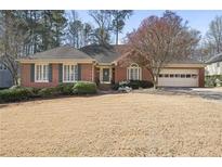 Charming brick ranch-style home with lush landscaping and an attached two-car garage at 549 Trailwood Sw Ln, Marietta, GA 30064