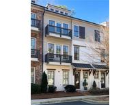 Charming townhome featuring multi-level balconies, neutral paint, and covered front entry at 217 Napa Dr, Woodstock, GA 30188