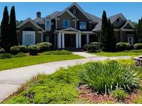 Stunning two-story home with a landscaped front yard and a welcoming entrance with white columns at 100 Annes Ln, Sharpsburg, GA 30277