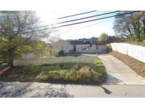 Modest single story home features a driveway and a white picket fence at 337 W Wieuca Ne Rd, Atlanta, GA 30342
