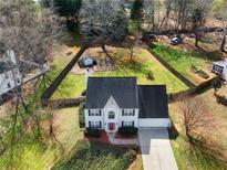 Stunning aerial view of a charming home, showcasing its spacious backyard and lovely landscaping at 6455 N Glen Dr, Cumming, GA 30028