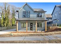 Charming two-story home features a stylish modern farmhouse elevation and a covered front porch at 1247 Bridges Sw Ave # A, Atlanta, GA 30310