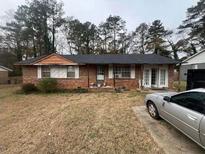 Charming single-story brick home with a well-maintained lawn and cozy curb appeal at 8947 Yarmouth Dr, Jonesboro, GA 30238