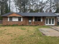 Charming brick home featuring a well-maintained lawn and a classic design at 8947 Yarmouth Dr, Jonesboro, GA 30238