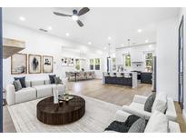 Open-concept living room flows into the kitchen with a modern island and dining area, perfect for entertaining at 1247 Bridges Sw Ave # B, Atlanta, GA 30310