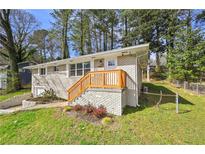 Charming brick home with a welcoming front porch and freshly painted wooden railing at 2587 Lancaster Dr, Atlanta, GA 30344