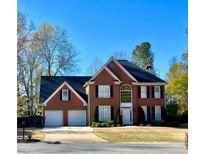 Charming two-story brick home with a well-manicured lawn, attached two-car garage, and beautiful front yard landscaping at 2996 Bea Mar Dr, Marietta, GA 30062